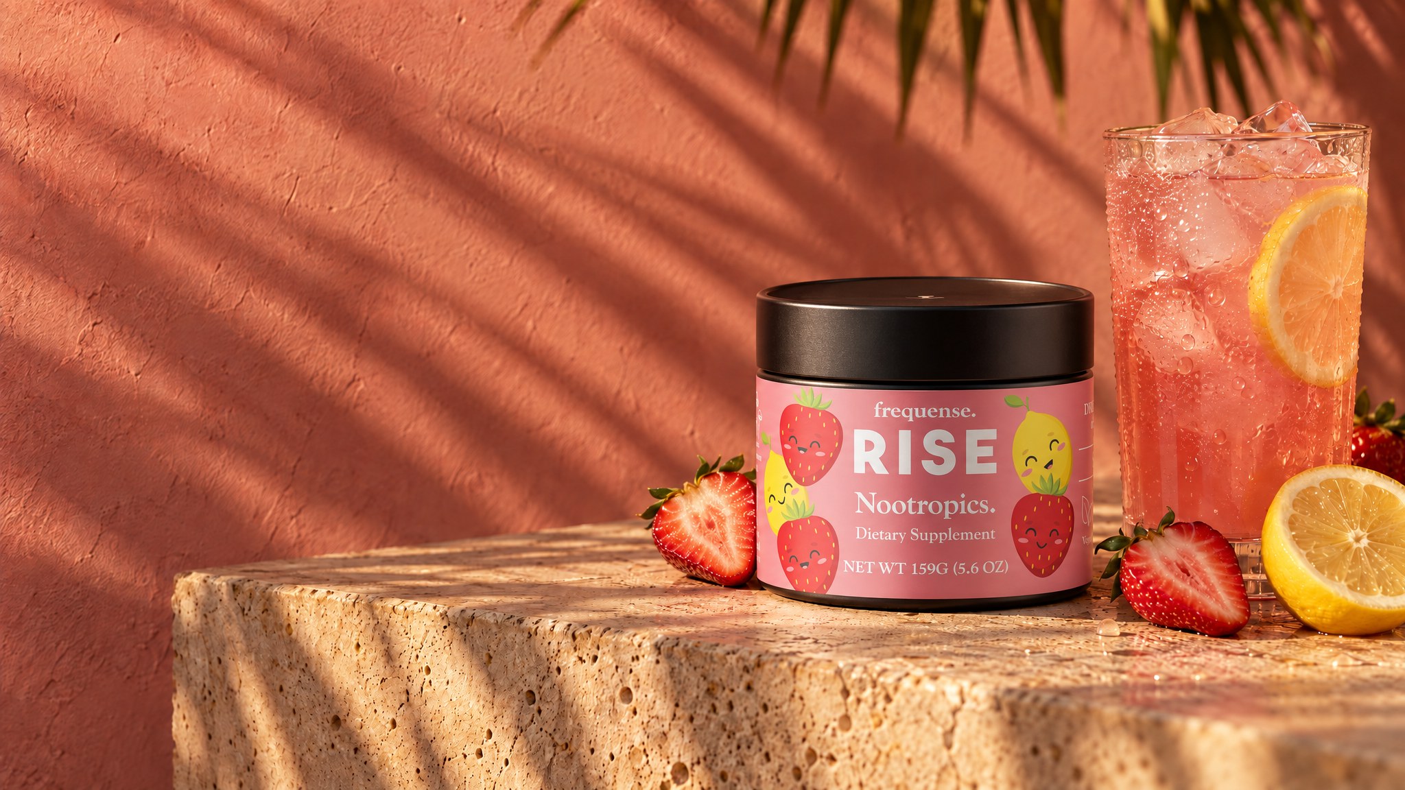 RISE Sweet 'N Tart jar on a travertine ledge beside iced strawberry lemonade, sunset palm shadows on a warm rose wall.