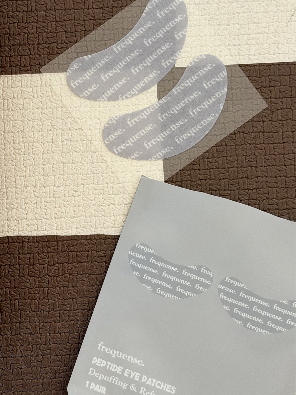 An individually packaged pair of Frequense Peptide Eye Patches with the patches removed
